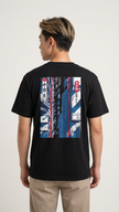 Person wearing a black t-shirt with a colorful graphic on the back, standing against a white background